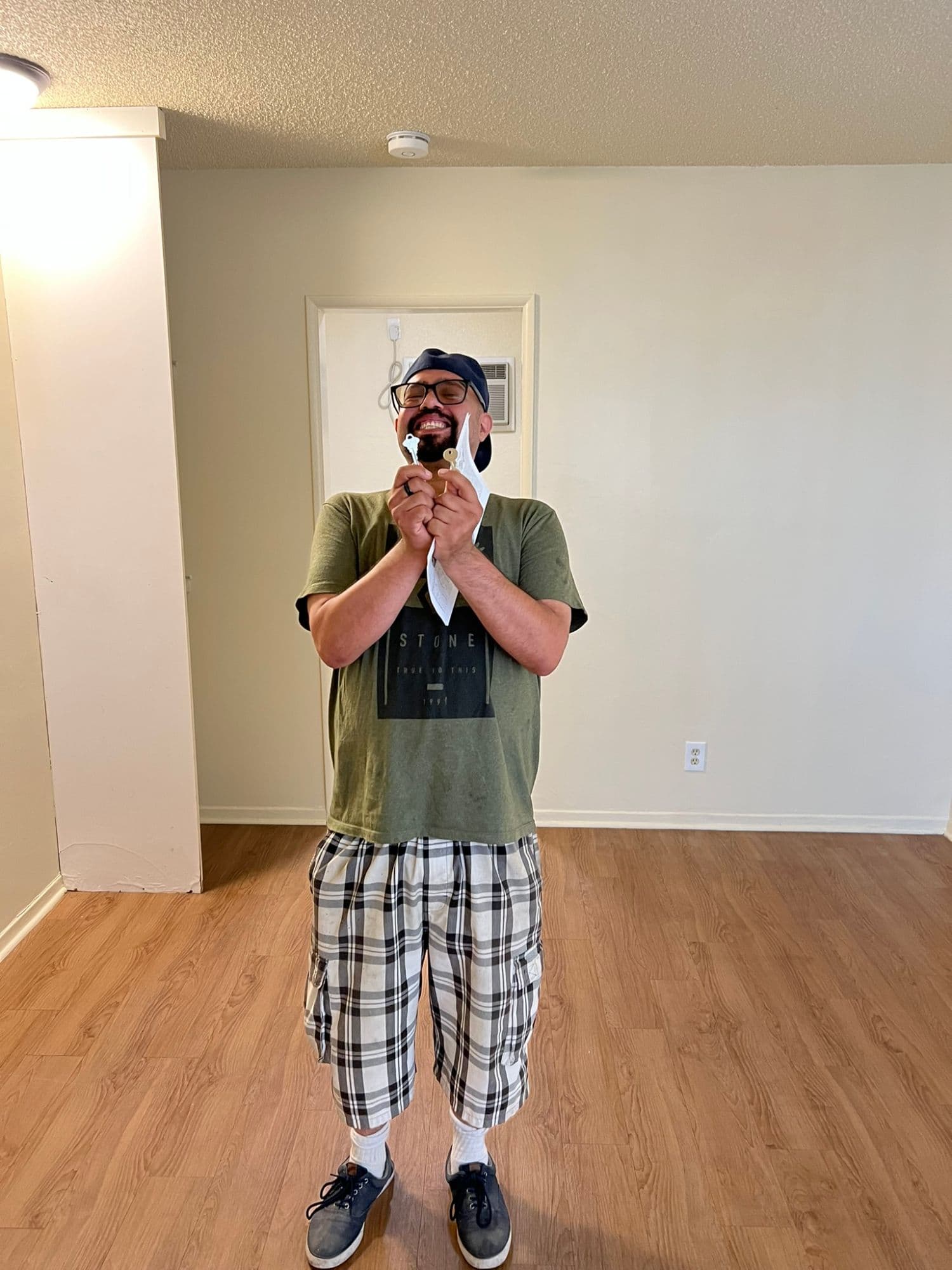 RO holding the keys to his first apartment on move-in day.